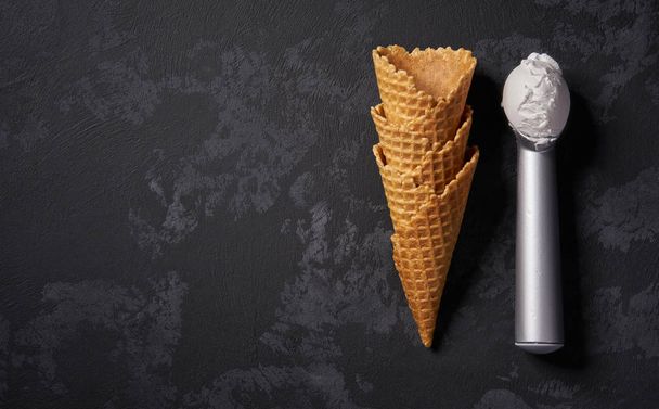 Waffle cones for ice cream and a  metal spoon waiting for fillin - Fotoğraf, Görsel