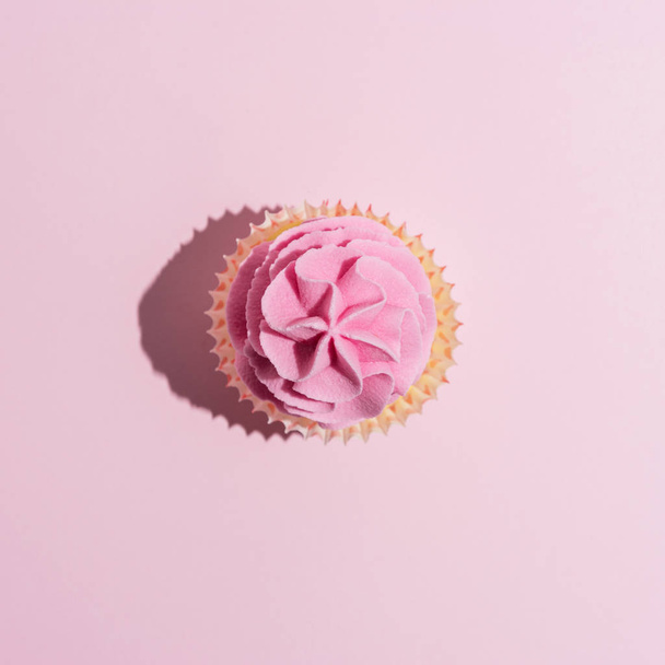 Colorful celebration background with cupcake. Minimal party concept. - 写真・画像