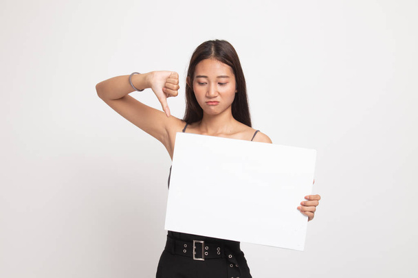 Young Asian woman show thumbs down with white blank sign. - Zdjęcie, obraz