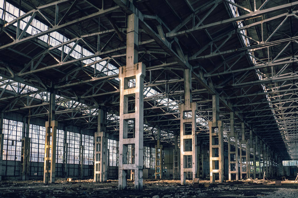 Ruined industrial hall of warehouse or hangar, creepy and old construction - Fotó, kép