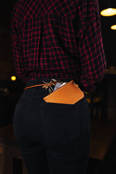 The purse on the belt of the girl in the bar - Fotoğraf, Görsel