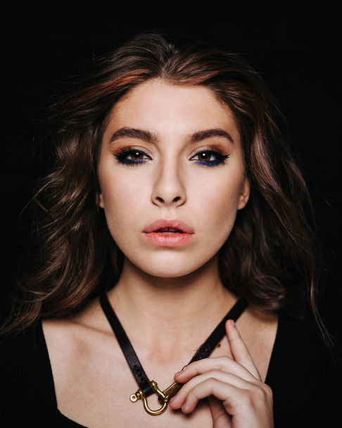 Beauty portrait of a young girl on a black background - Zdjęcie, obraz