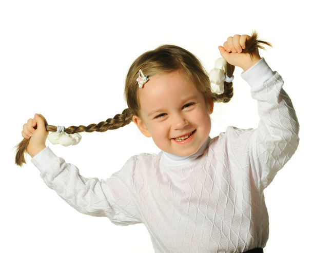 The little girl holds hands braids - 写真・画像
