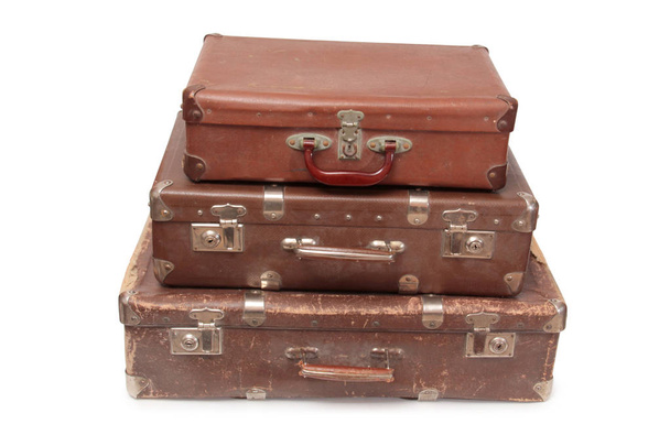 Ancient suitcase for travel on a white background - Foto, afbeelding