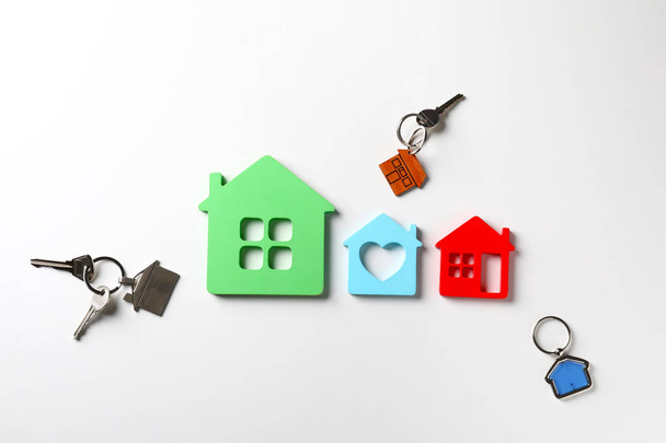 Models of house with keys on white background. Concept of earthquake - Photo, Image
