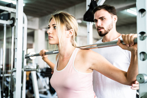 Sport man trainning women work out in fitness gym sport club - Foto, Imagem
