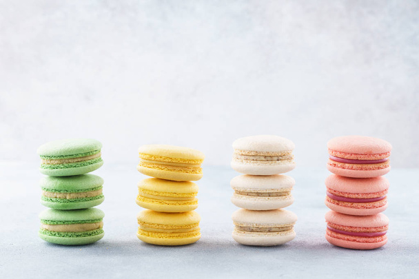 Stacks of various colorful macarons in a row. Creative design. - Photo, Image