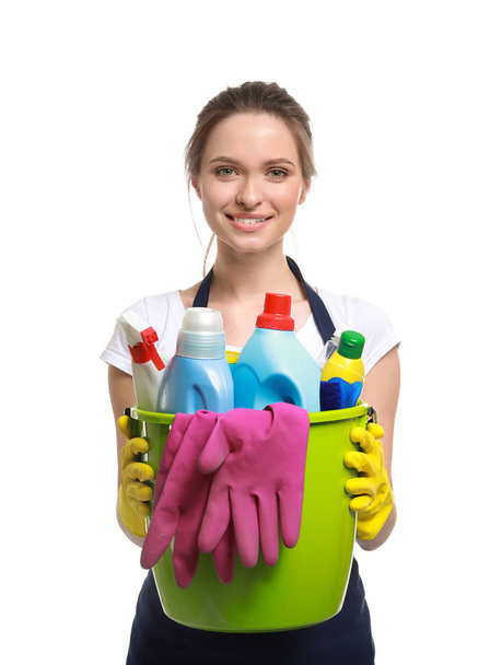 Portrait of female janitor with cleaning supplies on white background - Photo, Image