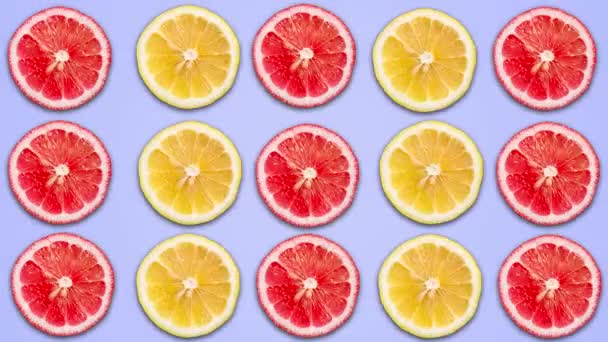 Absztrakt animáció a szeletelt citromot és a grapefruit a zöld pasztell háttérrel. 4 - Felvétel, videó
