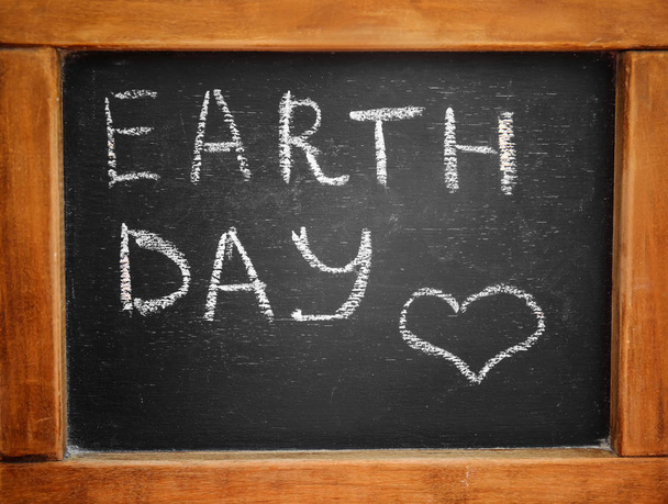 Chalkboard with text EARTH DAY outdoors, closeup - Foto, Imagen