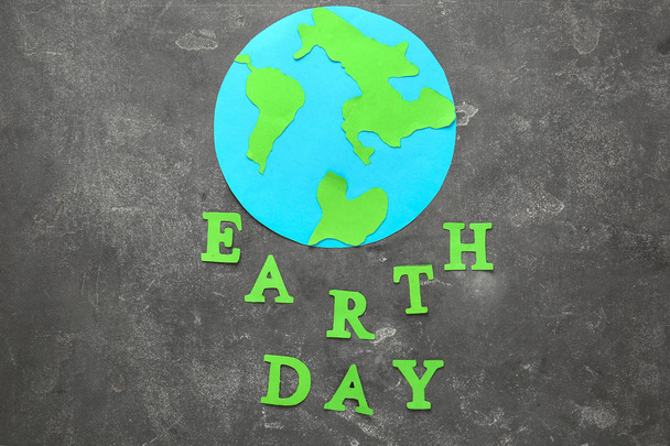 Text EARTH DAY composed from letters and shape of planet on grunge background - Photo, Image
