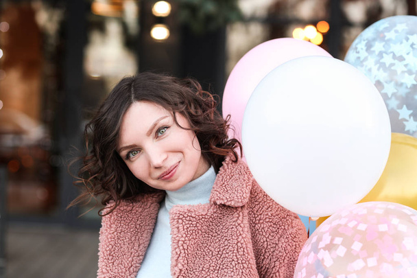 Portrait of happy girl with air balloons outdoors - Photo, Image
