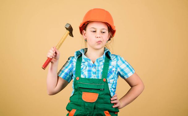 Future profession. Kid builder girl. Build your future yourself. Initiative child girl hard hat helmet builder worker. Tools to improve yourself. Child care development. Builder engineer architect - Foto, afbeelding