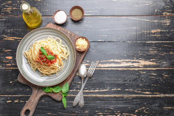 Plate with tasty boiled pasta on wooden table - Photo, Image