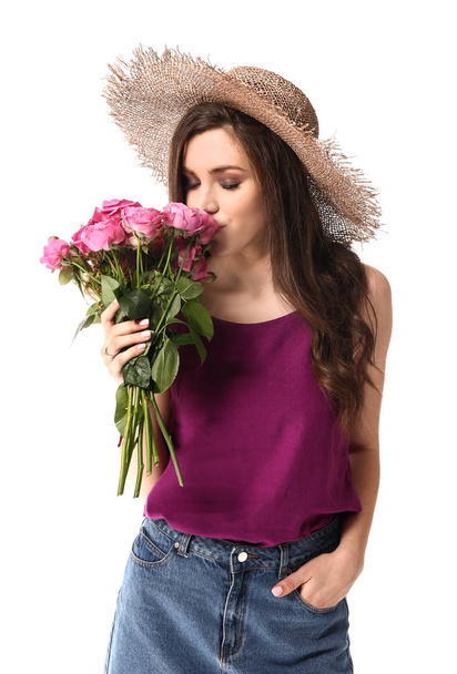 Beautiful young woman with bouquet of flowers on white background - Photo, Image