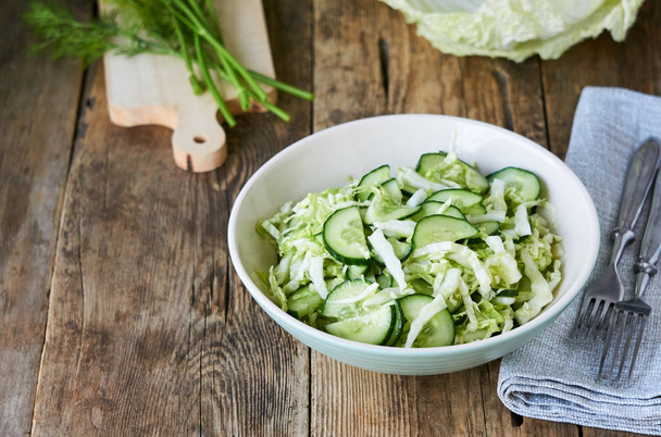 Salad with fresh chinese cabbage and cucumbers in a bowl                                - Foto, immagini