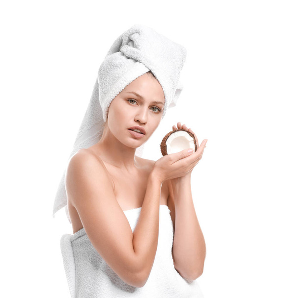 Beautiful young woman with coconut on white background - Φωτογραφία, εικόνα
