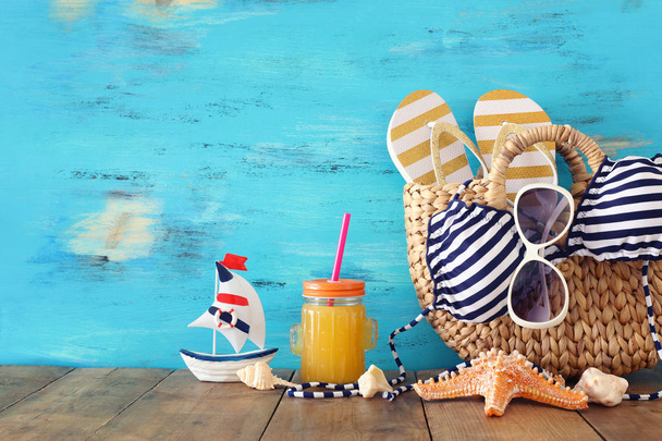 vacation and summer concept with sea life style objects and fresh fruit drink over wooden table - Foto, imagen