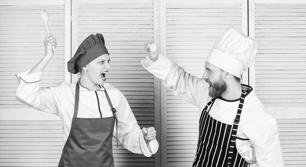 Who cook better. Culinary battle concept. Woman and bearded man culinary show competitors. Ultimate cooking challenge. Culinary battle of two chefs. Kitchen rules. Couple compete in culinary arts - Фото, изображение