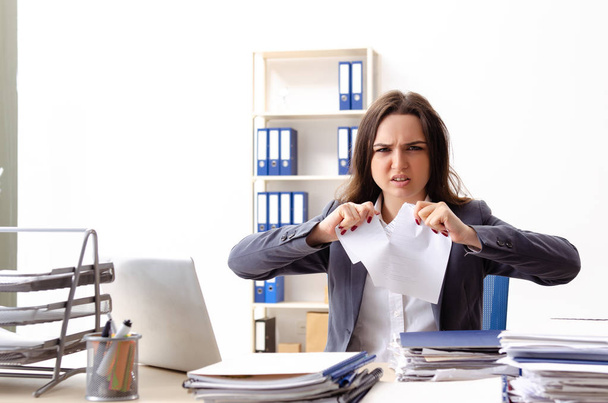 Young female employee unhappy with excessive work  - Photo, Image