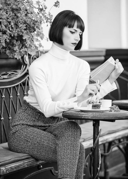 Literature for female. Mug of good coffee and pleasant book best combination for perfect weekend. Girl drink coffee read book. Woman have drink enjoy good book cafe terrace. Self improvement concept - Photo, image