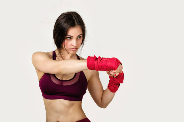 beautiful woman boxer with red strap on wrist. - Foto, Imagem