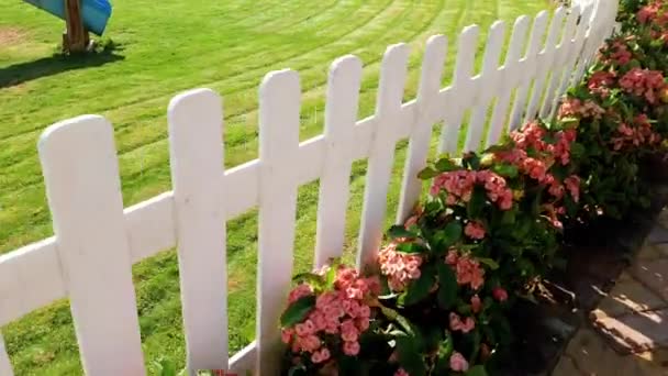 4k video of camera moving along beautiful white wooden fence and green grass on lawn - Footage, Video