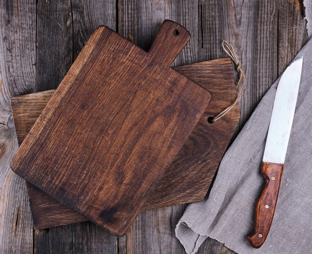 two old wooden cutting boards and a knife  - Photo, Image