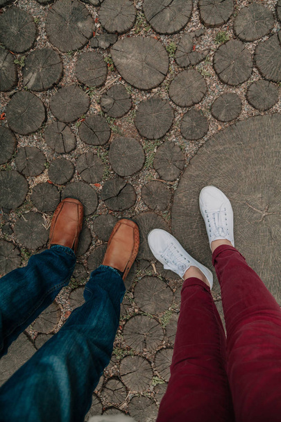 Summer romance. Legs of  man and woman on  wooden walkway - Foto, imagen