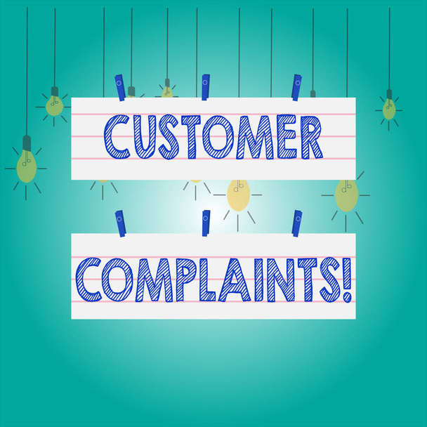 Word writing text Customer Complaints. Business concept for expression of dissatisfaction on a consumer s is behalf Two Color Blank Strip Size Lined Paper Sheet Hanging Using Blue Clothespin. - Fotoğraf, Görsel