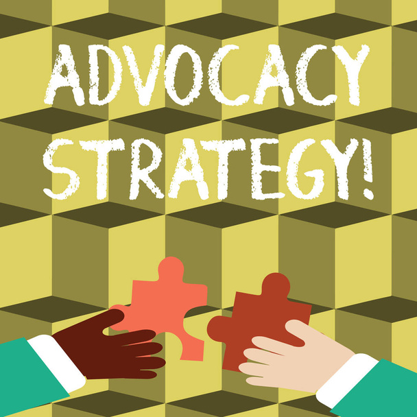 Writing note showing Advocacy Strategy. Business photo showcasing activity by an individual that aims to influence decisions Hands Holding Jigsaw Puzzle Pieces about Interlock the Tiles. - Photo, Image