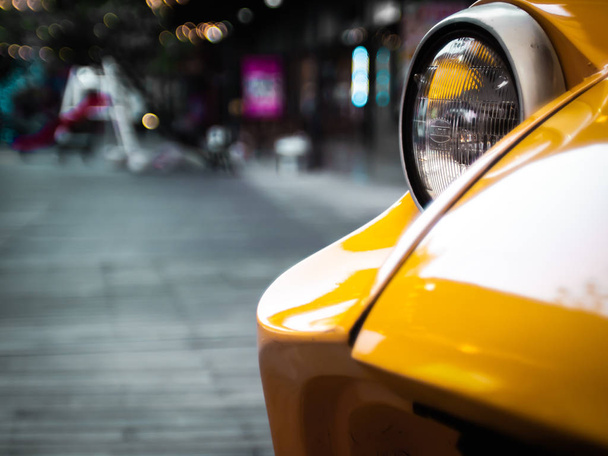 head light Sport car in yellow  close up .lifestyle concept idea.road trip .travel background - 写真・画像