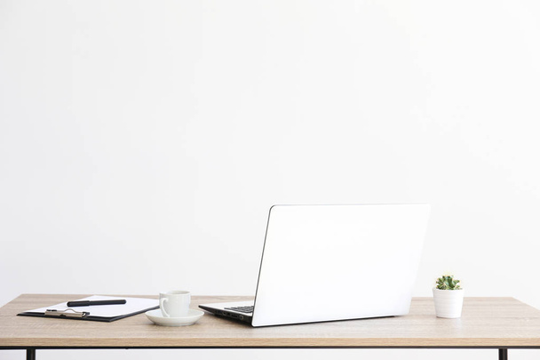 Minimalistic composition of workplace with laptop and stationery. - Foto, imagen