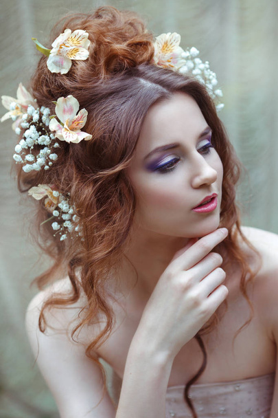 Portrait of a girl with hairstyle decorated with flowers - Foto, afbeelding