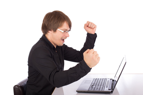 Hombre de negocios levanta los brazos delante de su portátil
 - Foto, Imagen