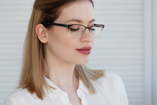 Stylish glasses in a thin frame, vision correction. Portrait of a young woman - Foto, immagini