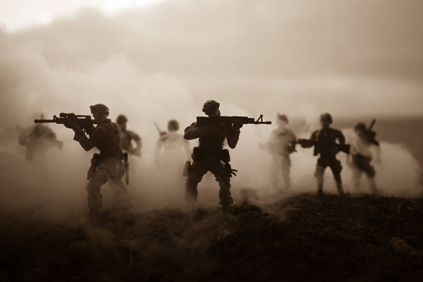 戦闘シーン。軍は、戦争の霧空を背景に戦闘シーンをシルエットします。世界大戦の兵士のシルエットの下曇りスカイラインで日没。アートワークの装飾。選択と集中 - 写真・画像