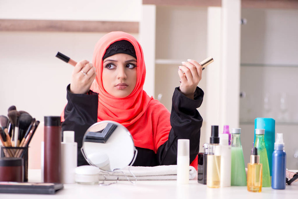 Beautiful woman in hijab applying make-up - Photo, Image