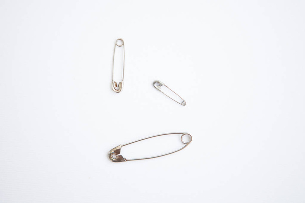 Set of safety pins on white background - Foto, afbeelding