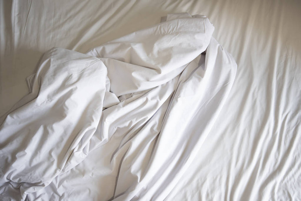 Niewykonane pościel z fałdowania i białego koca w sypialni po snu na widok z góry/pomarszczone tkaniny - Zdjęcie, obraz
