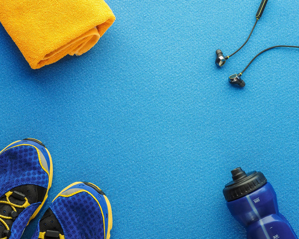 Sports equipment flat lay composition, running shoes, yellow tow - 写真・画像