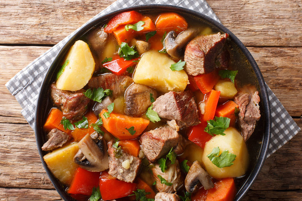 pork stew with mushrooms, potatoes, carrots and peppers close-up - Photo, Image