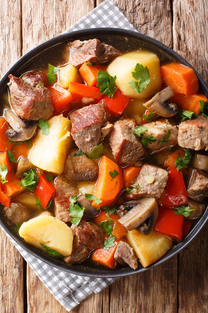 Tasty thick stew pork with mushrooms, potatoes, carrots and pepp - Photo, Image