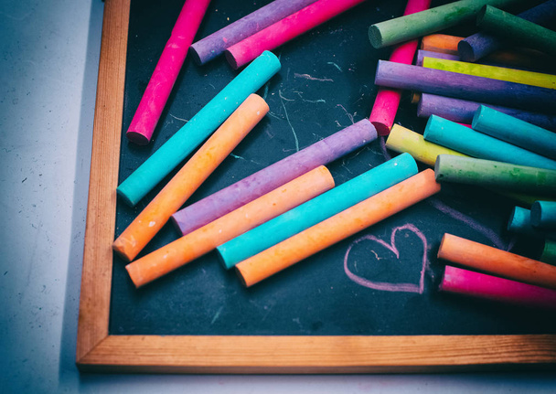 The abstract art design background of colorful chalks put on blackboard - Photo, image