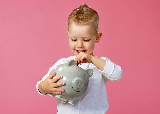 financial concept of children's pocket money. child boy with pig - Photo, Image