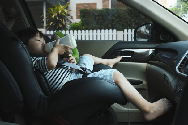 baby boy sucking milk on car seat safety drive - Φωτογραφία, εικόνα