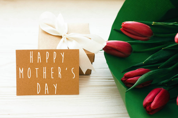 Happy Mother's Day text and beautiful red tulips with gift box o - Photo, Image