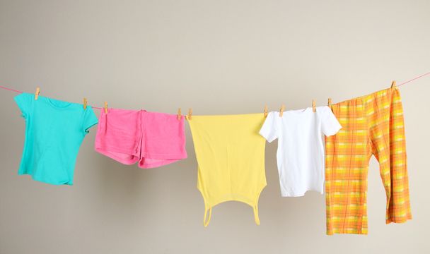 Laundry line with clothes on wall background - 写真・画像