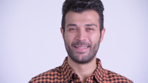 Face of happy bearded Persian hipster man smiling - Filmagem, Vídeo