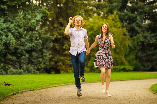 Happy couple playing in park - Zdjęcie, obraz